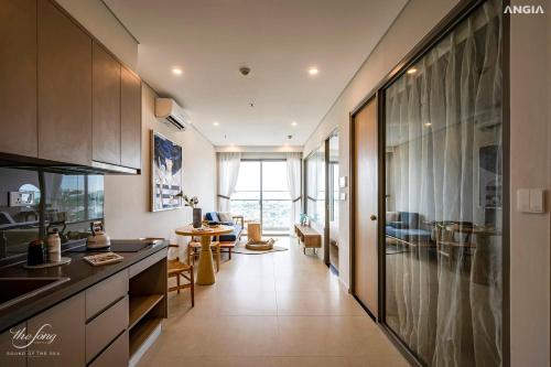 a kitchen with a long hallway with a living room at BIG SALE 33percent The Song An Gia Vung Tau - Luxury 2Beds Apartment in Vung Tau