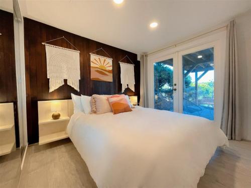 um quarto com uma grande cama branca e uma janela em PA Kirks Bluff em Port Angeles