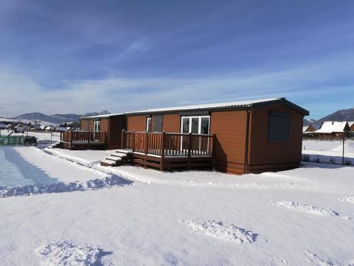 a small cabin in the snow with snow at Amis apartmán 1 in Liptovský Mikuláš