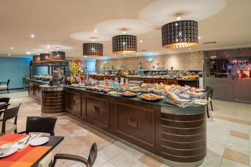 a breakfast buffet in a restaurant with tables and chairs at Radisson Blu Hotel, Yanbu in Yanbu