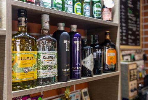 a shelf filled with lots of bottles of alcohol at Betli Panzió in Zalaegerszeg