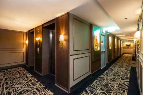 a corridor of a hotel with a hallway of a room at The Coach Hotel Sukhumvit - Asok BTS Bangkok in Bangkok
