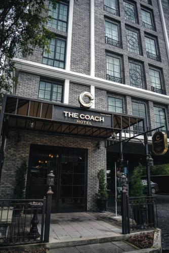 a building with a sign that reads the coach hotel at The Coach Hotel Sukhumvit - Asok BTS Bangkok in Bangkok