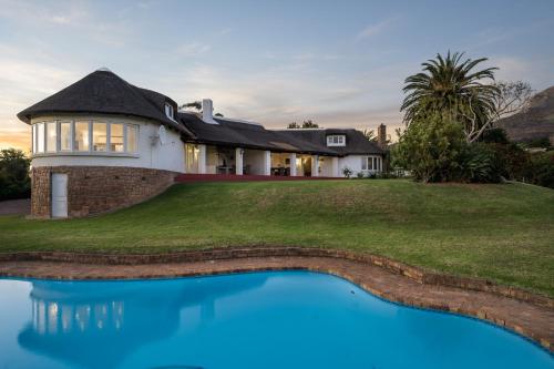 a house with a swimming pool in front of it at La Felicita Boutique Self Catering Villas in Somerset West