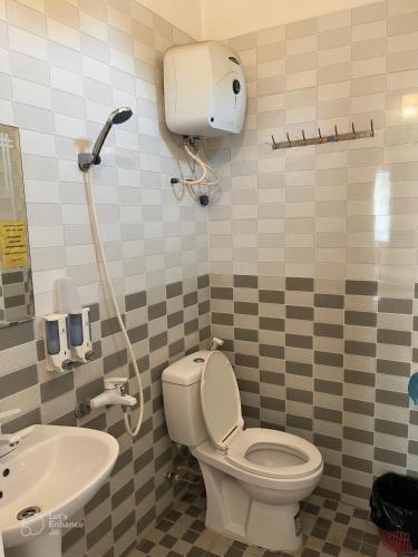 a bathroom with a toilet and a sink at Cat Ba Sweet Potato Homestay in Cat Ba