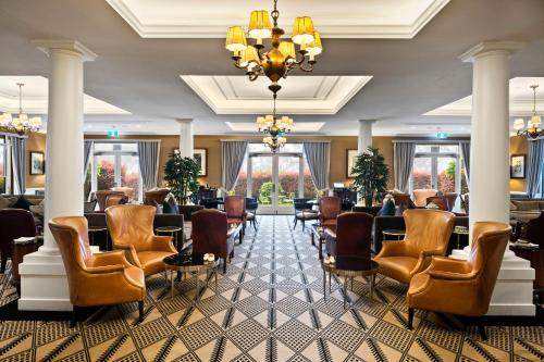 a lobby with a waiting room with chairs and a chandelier at Lilianfels Blue Mountains Resort & Spa in Katoomba