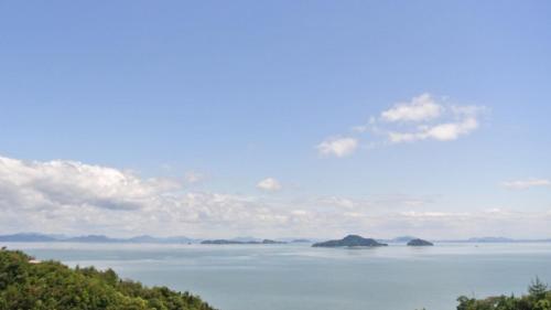 a view of the water with islands in the distance at Kyukamura Setouchi-Toyo in Saijo