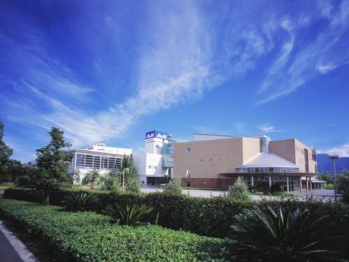 a view of a building with a blue sky at Kyukamura Setouchi-Toyo in Saijo