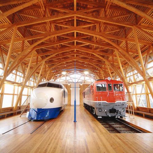 two trains are parked in a train station at Kyukamura Setouchi-Toyo in Saijo