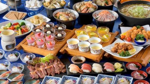 a table topped with lots of different types of food at Kyukamura Setouchi-Toyo in Saijo