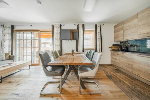 a dining room with a wooden table and chairs at Dachstein West Apartment 1B in Russbach am Pass Gschütt