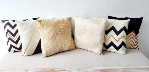 a group of pillows sitting on top of a bed at Villa Mosel Bali in Banjar