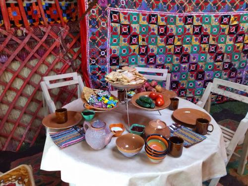 a table with a plate of food on it at Son-Kul Northen yurt camp in Kochkor
