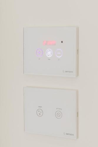 a set of three white boxes with logos on them at Muller Hotel Boutique & Spa in Galaţi