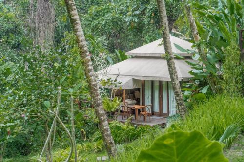 a tent in the middle of the forest at Galalima Glamping in Meliling
