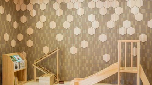 a room with a crib and a wall with hearts at Kyukamura Oku-Musashi in Hanno