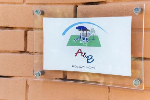 a sign for a holiday home hanging on a brick wall at Relax a due passi dal mare in Piazza