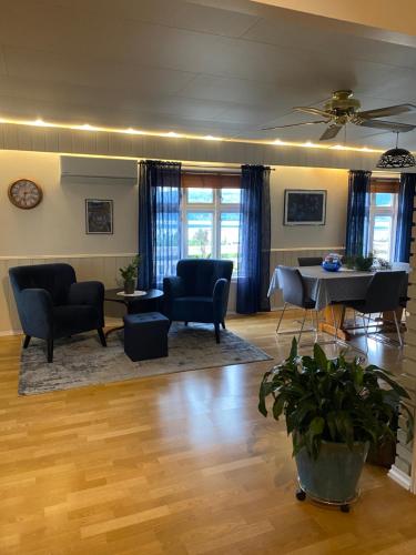 a living room with a table and chairs and a piano at The house of Mattis in beautiful Innvik in Innvik