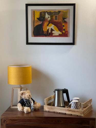 a teddy bear sitting on a table with a lamp at Le Mas de Mirabel in Mirabel-aux-Baronnies
