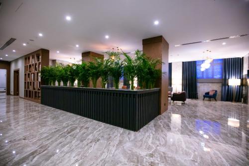 a lobby with potted plants on a counter at Wyndham Garden Baku in Baku
