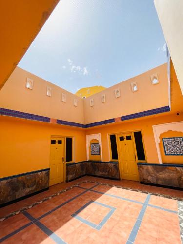 an empty room with orange walls and yellow doors at Anand Bagh Resort & Spa by Ananta in Sālāsar