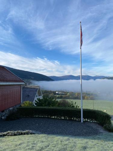a flag pole in front of a house with a view at The house of Mattis in beautiful Innvik in Innvik