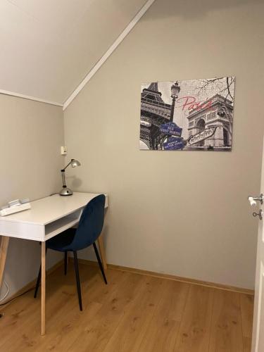 a desk in a room with a painting on the wall at The house of Mattis in beautiful Innvik in Innvik
