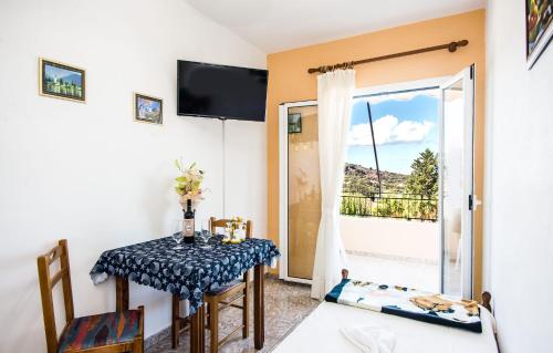 a dining room with a table and a window at Aristotelis Apartments in Razáta