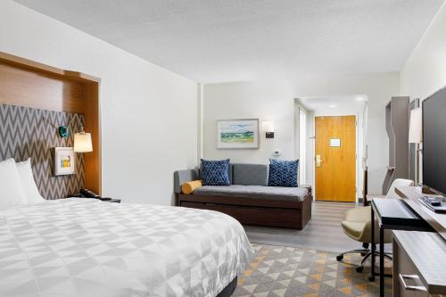 a hotel room with a bed and a couch at Holiday Inn Cleveland, an IHG Hotel in Cleveland