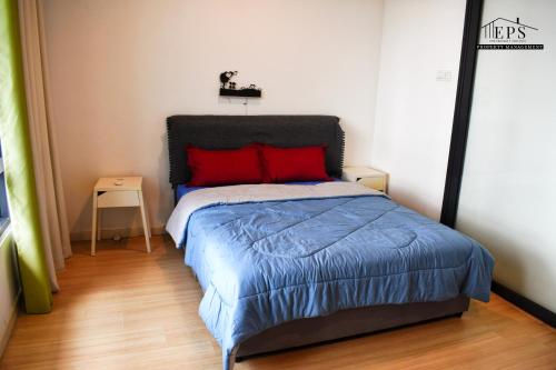 a bedroom with a bed with a red pillow at USJ One HomeStay @ Subang HomeStay in Subang Jaya