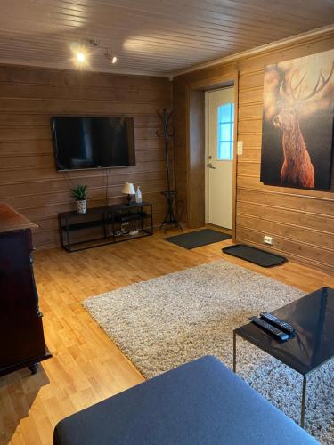 a living room with a flat screen tv on the wall at The house of Mattis in beautiful Innvik in Innvik