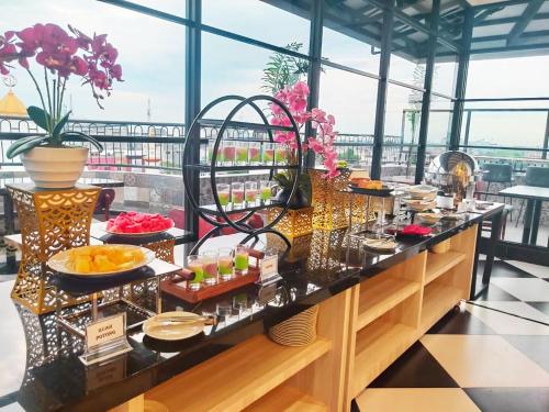 a breakfast buffet on the floor of a building at Kesuma Front One Boutique Palembang in Palembang