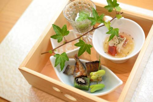 a wooden box with two plates of food on it at Hakone Gora Byakudan in Hakone