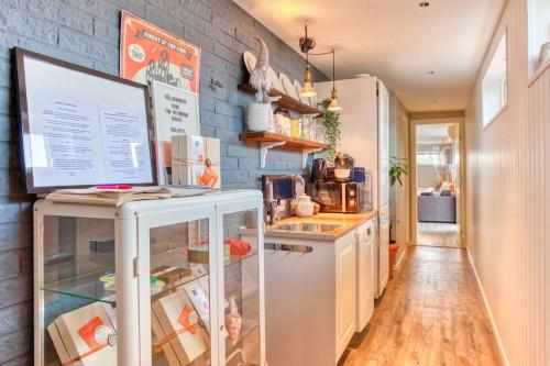 a kitchen with a white refrigerator and a brick wall at Stockholms home away from home in Stockholm