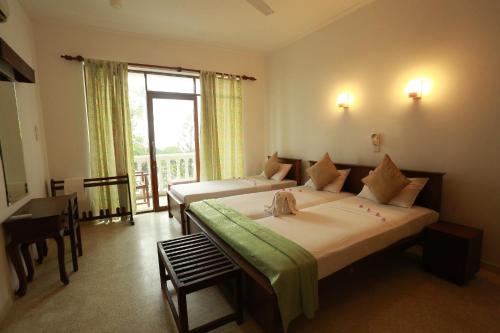 Voodi või voodid majutusasutuse Sumadai Beach Hotel toas