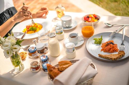 a white table with plates of food on it at Hotel Villa Barbarich Venice Mestre in Mestre