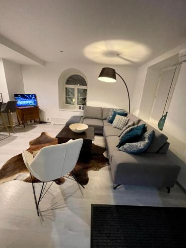 a living room with a couch and a table at Luxury penthouse with terrace & sauna in Old Town in Tallinn