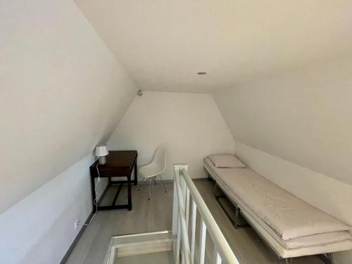 a small room with a bed and a desk at Luxury penthouse with terrace & sauna in Old Town in Tallinn