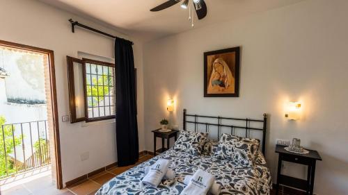 a bedroom with a bed and a window at Fuente de la Gitana Rute by Ruralidays in Rute