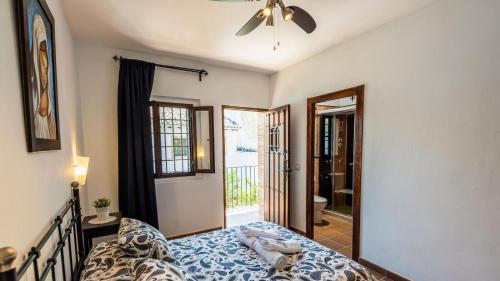 a bedroom with a bed and a window at Fuente de la Gitana Rute by Ruralidays in Rute