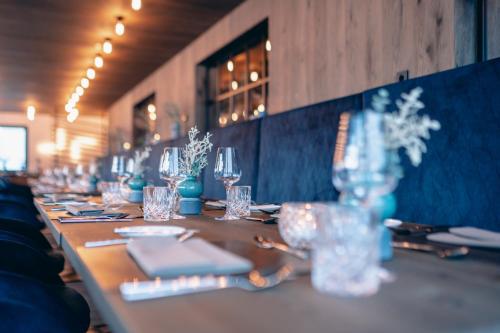 a long table with glasses and napkins on it at ZillergrundRock Luxury Mountain Resort in Mayrhofen