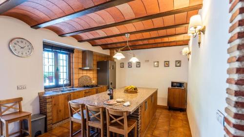 a kitchen with a table and chairs in a room at Fuente de la Gitana Rute by Ruralidays in Rute