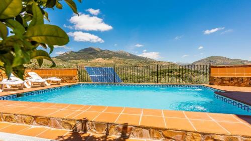 a swimming pool with a view of mountains at Fuente de la Gitana Rute by Ruralidays in Rute