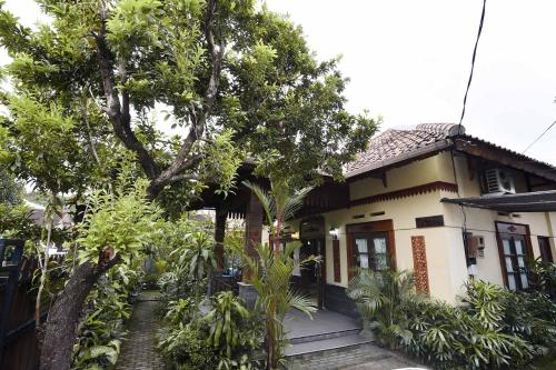 a small house with trees in front of it at Ndalem Maharani Guest House in Yogyakarta