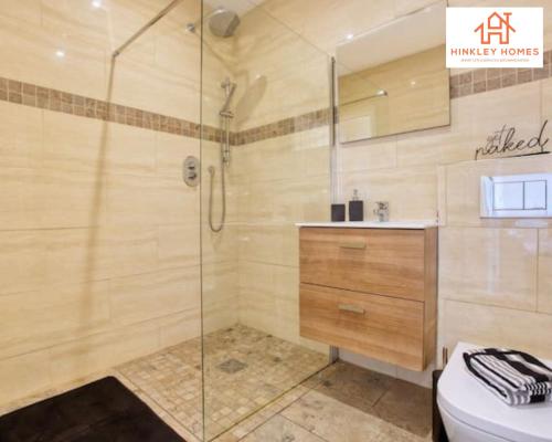 a bathroom with a shower and a sink and a toilet at Immaculate City Centre - HPC links - 5 - Parking By Hinkley Homes Short Lets & Serviced Accommodation in Bridgwater