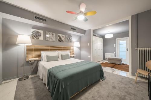 a bedroom with a bed and a ceiling fan at Luxurious apartment in Kolonaki in Athens