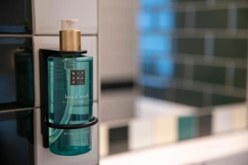a green bottle of soap sitting on a counter at Bed & Bos de 14 Sterren in Den Burg