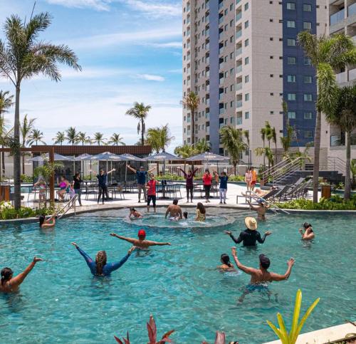 a group of people swimming in a swimming pool at Salinas Premium Resort in Salinópolis