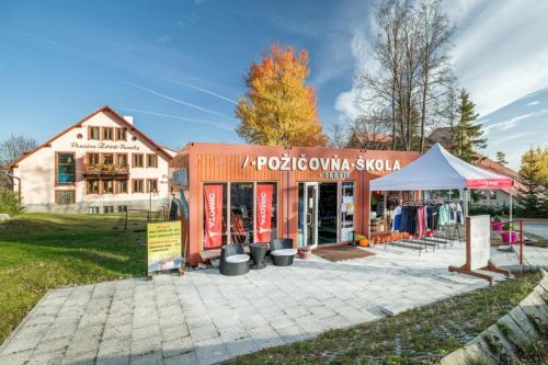 a store with a tent in front of a building at Wellness Penzion Zora Family in Tatranská Lomnica