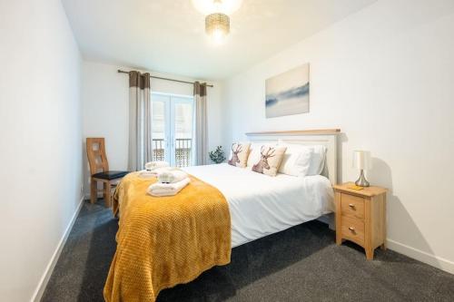 Un dormitorio con una cama con una manta amarilla. en Modern City Centre Apartment in Inverness, en Inverness